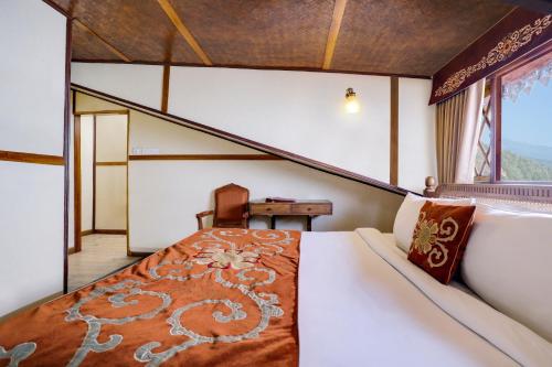 a large bed in a room with a window at Summit Hermon Hotel & Spa in Darjeeling