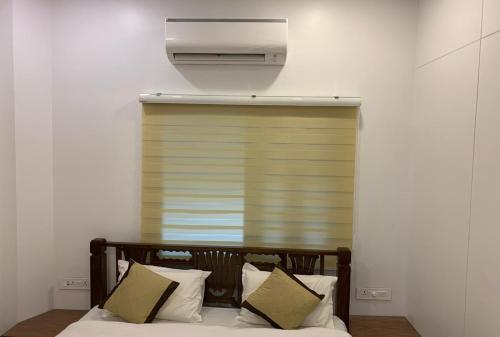 a bedroom with a bed and a air conditioner at Carlton Hotel Mumbai - Behind Taj Mahal Palace Colaba Mumbai in Mumbai