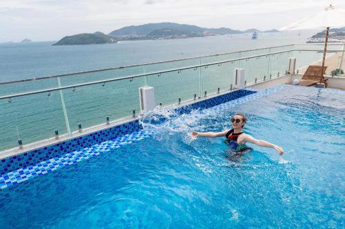 a woman in a swimming pool on a cruise ship at Sun Kiss Hotel in Nha Trang