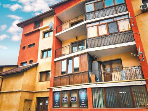 a tall building with balconies on the side of it at Cozy Studio in Cugir