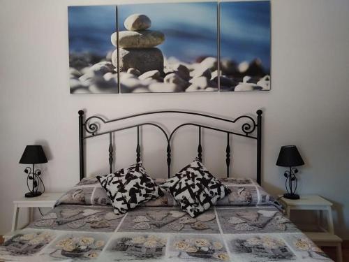 a bedroom with a bed with a pile of rocks on it at Le Anfore in Marino