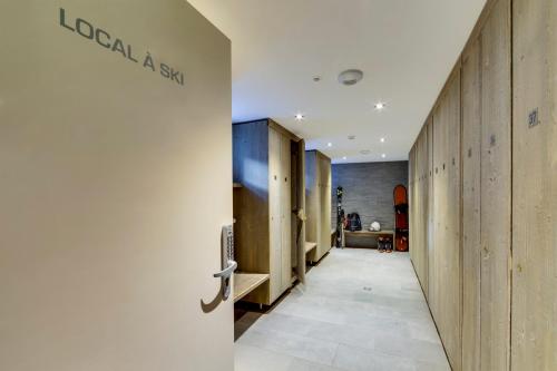 a corridor of a dressing room with a sign on the wall at La Galise in Val dʼIsère