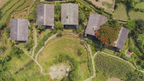 an overhead view of a group of buildings in a field at The Pavilions Himalayas The Farm in Pokhara