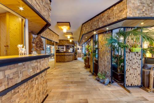a lobby of a restaurant with a brick wall at La Galise in Val dʼIsère