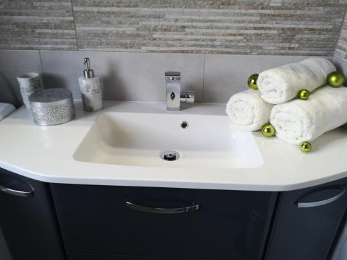 a bathroom sink with towels on top of it at APP Vanja 6170 in Čatež ob Savi