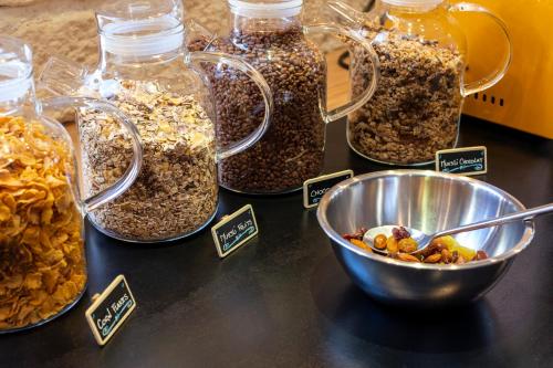 a table with jars of granola and a bowl of nuts at La Galise in Val dʼIsère