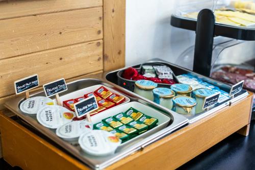 a tray filled with different types of food on a table at La Galise in Val dʼIsère