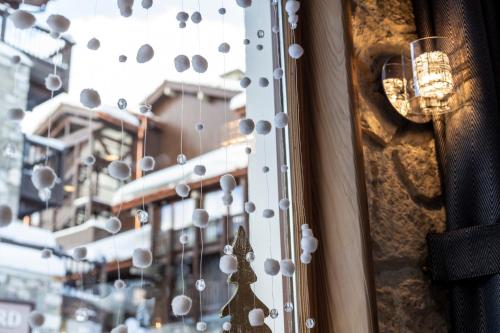 a window with christmas ornaments on a building at La Galise in Val dʼIsère