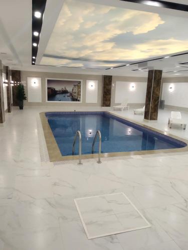 a large swimming pool in a hotel room at KavKaz Hotel & Restaurant in Marneuli