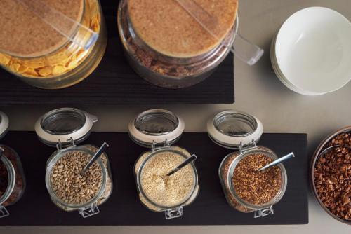a bunch of different types of food in jars at briig boutique hotel in Split