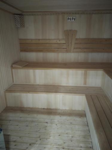an empty sauna with wooden shelves in a room at KavKaz Hotel & Restaurant in Marneuli