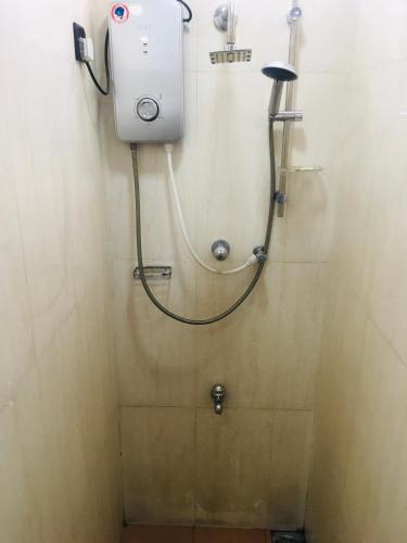 a shower in a bathroom with a hose attached to the wall at View City Point in Kandy