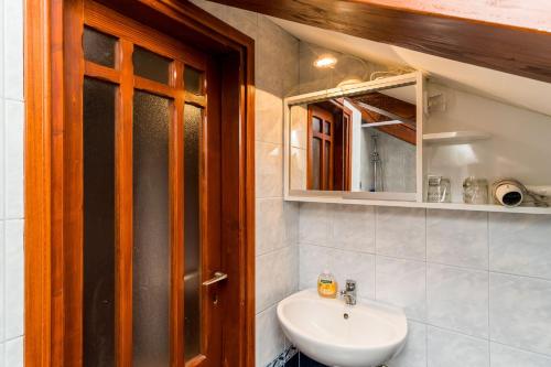 a bathroom with a sink and a mirror at Villa Odak in Dubrovnik