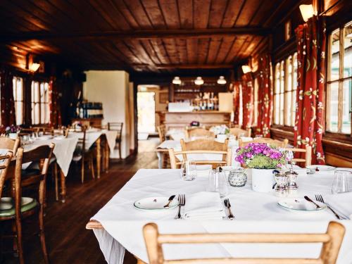 a dining room with white tables and chairs at TAUROA Krenn in Pürgg