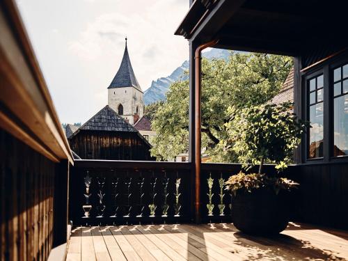 a balcony with a view of a church at TAUROA Krenn in Pürgg