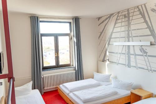 Ένα ή περισσότερα κρεβάτια σε δωμάτιο στο havenhostel Bremerhaven