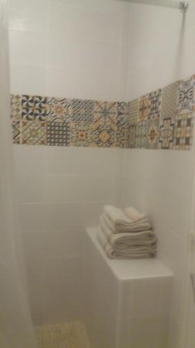 een stapel handdoeken op een plank in een badkamer bij STUDIO 3mn A PIED DE LA PLAGE AVEC TERRASSE in Antibes