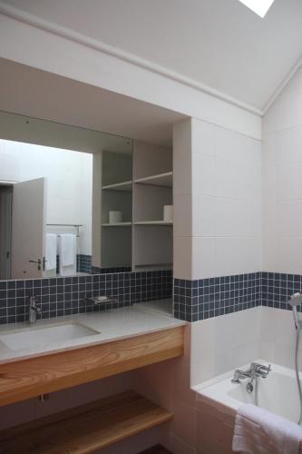 a bathroom with a sink and a mirror at The Boardwalk Accommodation in Gordonʼs Bay