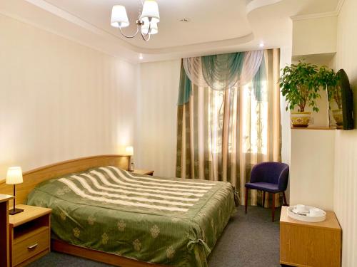 A bed or beds in a room at Business Hotel Kostroma