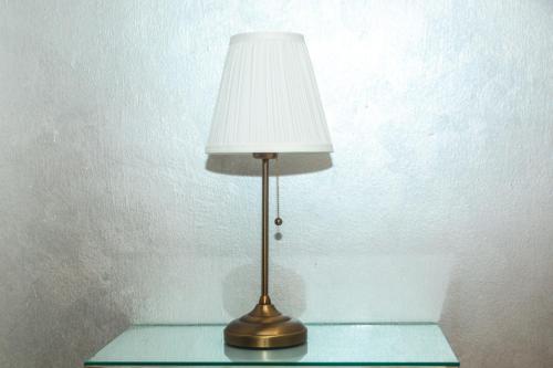 a lamp sitting on top of a glass table at See&Sun in Ashdod