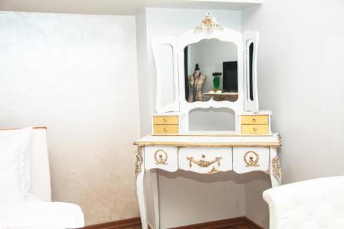 a bedroom with a white dresser with a mirror at See&Sun in Ashdod