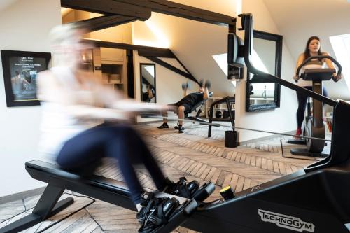 a group of people exercising on a treadmill in a gym at Hotel Arok in Strasbourg