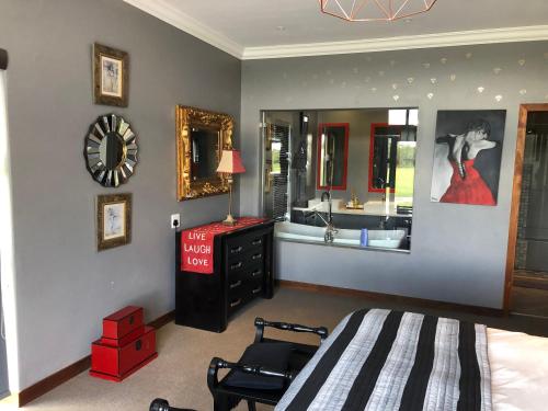 a bedroom with a bed and a dresser and a mirror at 142 Vaal de Grace in Parys