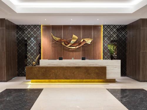 a lobby with a reception desk in a building at Aston Gresik Hotel & Conference Center in Gresik