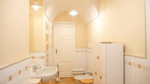 a white bathroom with a sink and a toilet at B&B S. Teresa in Altamura