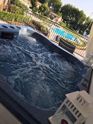 a large swimming pool with water in a backyard at Ludwig Boutique Hotel & Spa in Bolsena