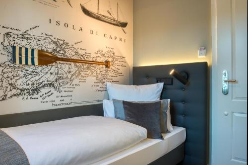 a bedroom with a bed and a map on the wall at Boutique 53 & 56 Hamburg City, Trademark Collection by Wyndham in Hamburg