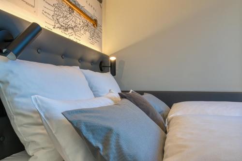 a bedroom with two beds with white pillows at Boutique 53 & 56 Hamburg City, Trademark Collection by Wyndham in Hamburg