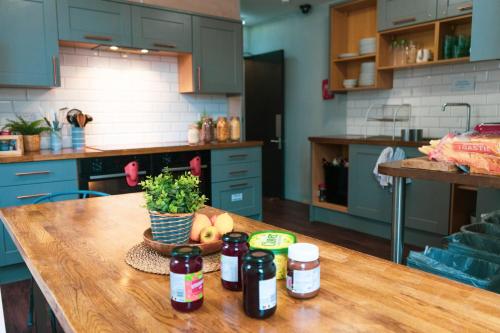 a kitchen with a wooden table with a bowl of fruit at Haystack Hostel in Edinburgh