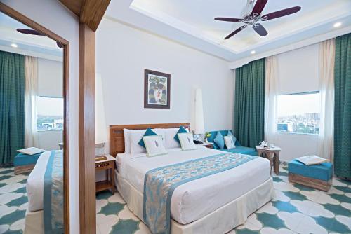 a hotel room with a bed and a ceiling fan at Clarks Amer in Jaipur