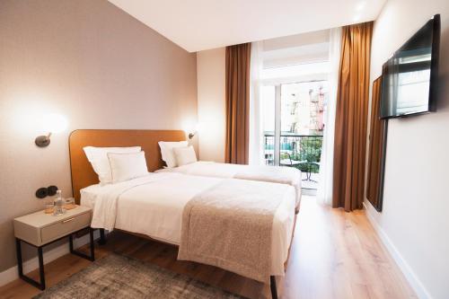 Кровать или кровати в номере LX SoHo Boutique Hotel by RIDAN Hotels