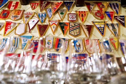 a bunch of glasses are lined up against a wall at Locanda del Lupo in Faenza