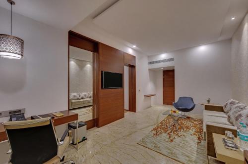 a large living room with a desk and a chair at The Fern Residency Sarnath in Varanasi