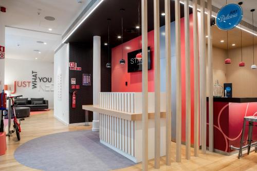 a store lobby with a red and white wall at Stay Hotel Lisboa Centro Chiado in Lisbon