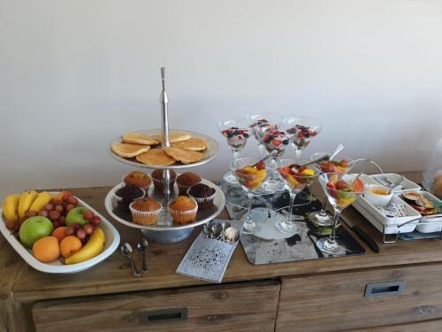 a buffet with various foods and desserts on a table at C' la Vie Luxury Accommodation in Melkbosstrand