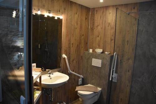 a bathroom with a sink and a toilet and a shower at Landhotel Anna in Sankt Martin am Tennengebirge