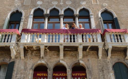 people on a balcony of a building at Hotel Palazzo Vitturi in Venice