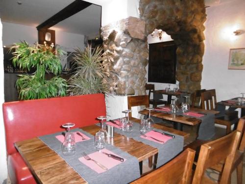 a dining room with a table and chairs in a restaurant at Le Relais Des Vieilles Postes in Les Avenières
