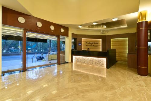 
a large room with a large mirror and a large window at Panchavati Elite Inn in Nashik
