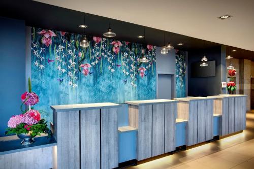 a lobby with a flower mural on the wall at Leonardo Hotel Swindon in Swindon