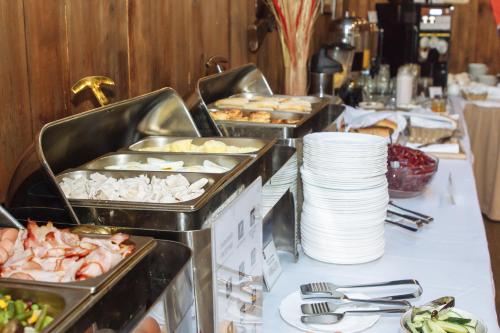 a buffet with several trays of food on a table at Reikartz Sumy in Sumy
