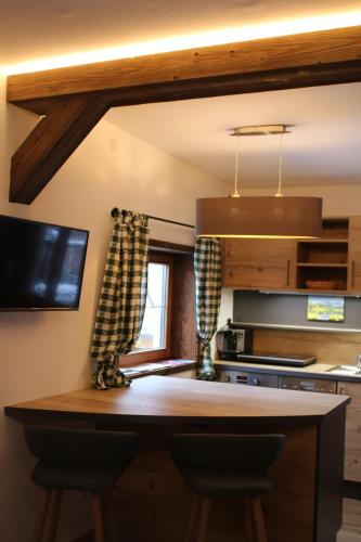 a kitchen with a wooden counter top and a window at 's Gasthäusl in Kirchberg in Tirol