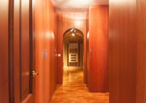 a hallway with wooden walls and an open door at BYPILLOW Villa Lorena Adults Recommended in Málaga