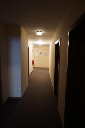 a hallway in an office building with a dark hallway at Hotel-Restaurant Weinhaus Grebel in Koblenz