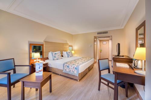 a hotel room with two beds and a desk at Seven Seas Hotel Life - Ultra All Inclusive & Kids Concept in Kemer