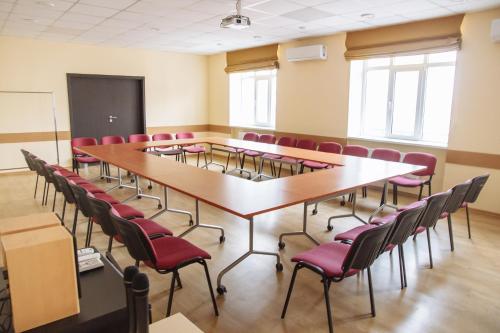 a conference room with a large table and chairs at Optima Sumy in Sumy